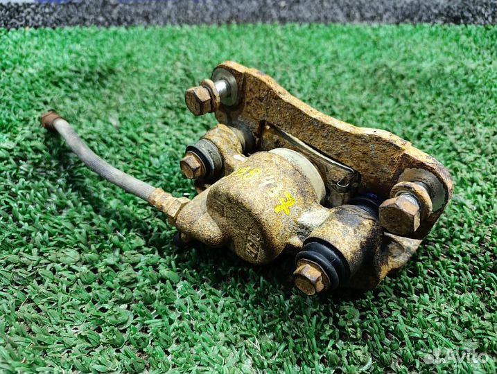 Суппорт тормозной задний левый Mitsubishi Pajero Sport