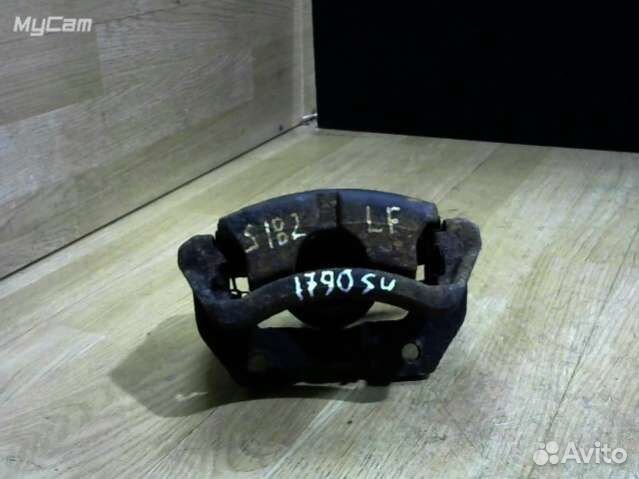 Суппорт тормозной передний левый Nissan Almera Tin