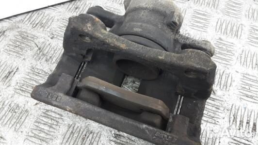 Суппорт тормозной передний левый nissan note E11