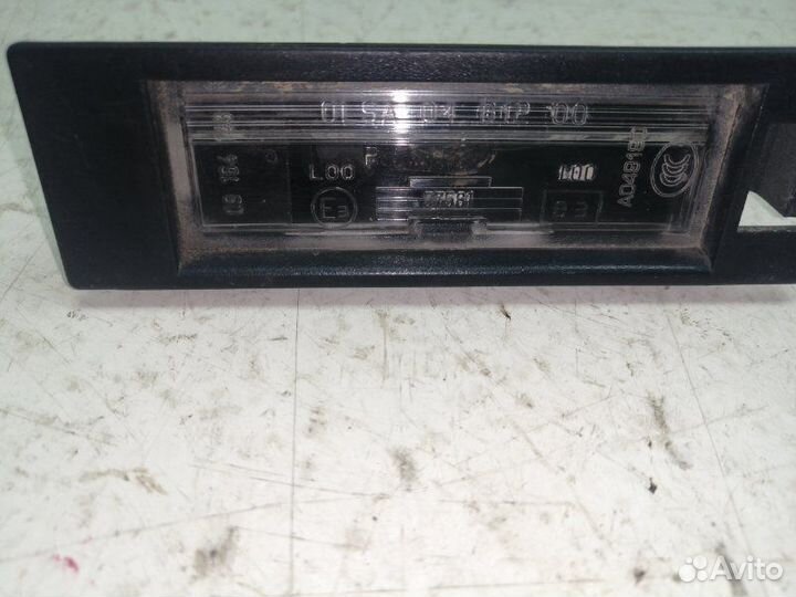 Фонарь освещения номерного знака Opel Astra H