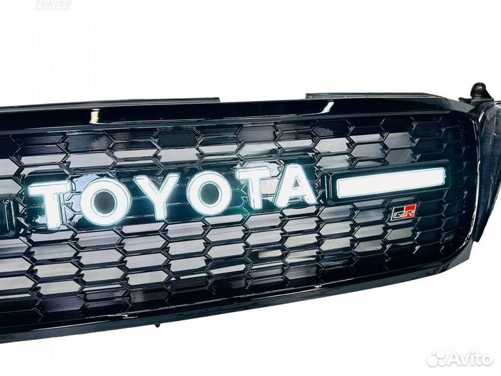 Фары (темные) с решеткой Toyota Land Cruiser 100 C