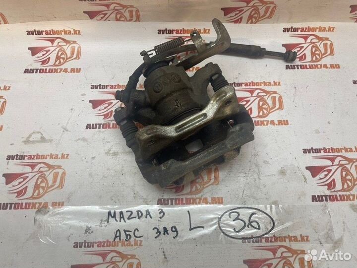 Суппорт тормозной задний левый Mazda 3 BM хетчбек