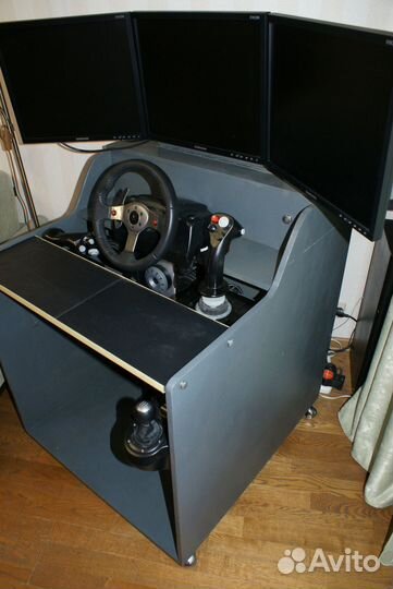 Компьютерный стол с мониторами и джойстиками