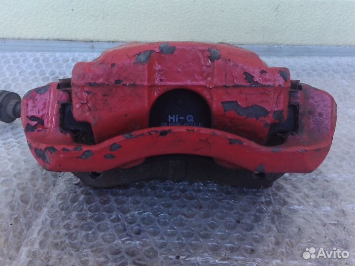 Шевроле Авео Т300 левый тормозной суппорт