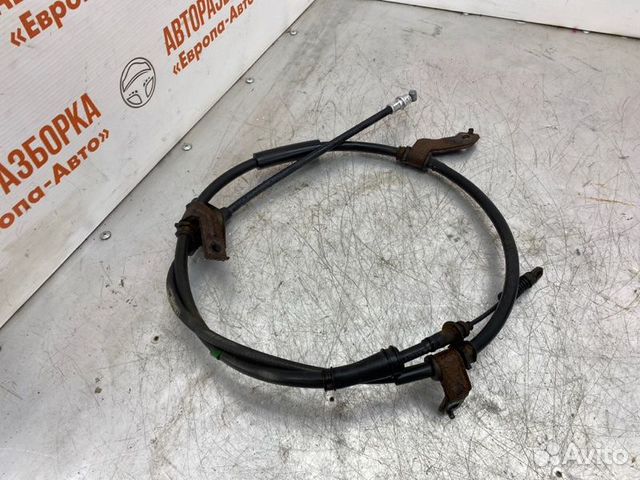 Трос стояночного тормоза левый Hyundai Sonata Nf