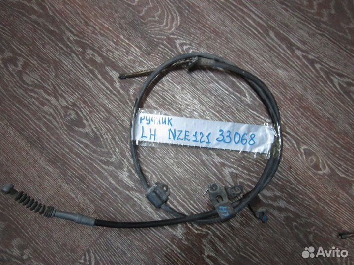 Трос ручника левый Toyota Corolla Fielder NZE121