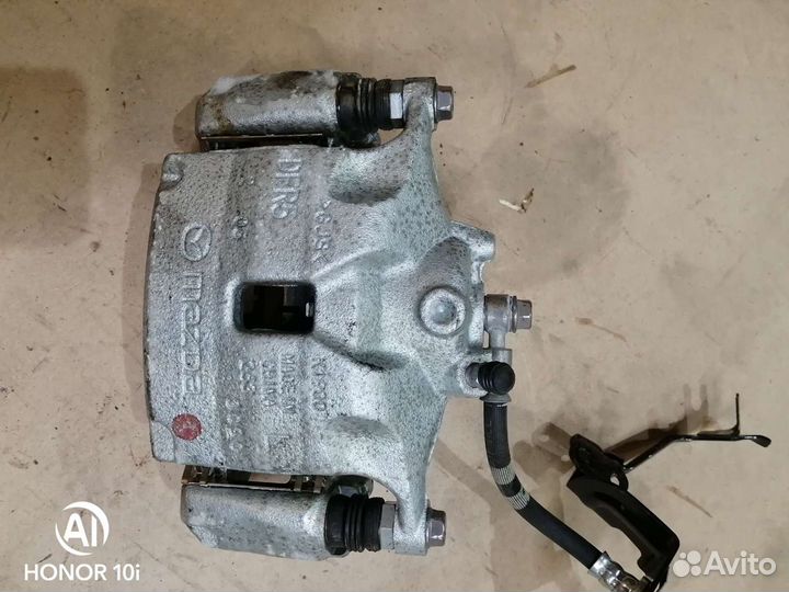 Суппорт тормозной передний левый Mazda CX-30