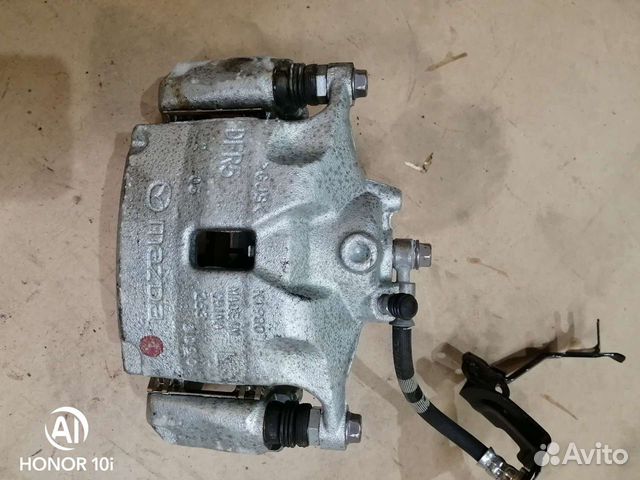 Суппорт тормозной передний левый Mazda CX-30