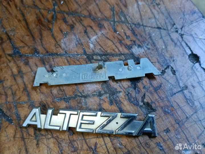Altezza Эмблема