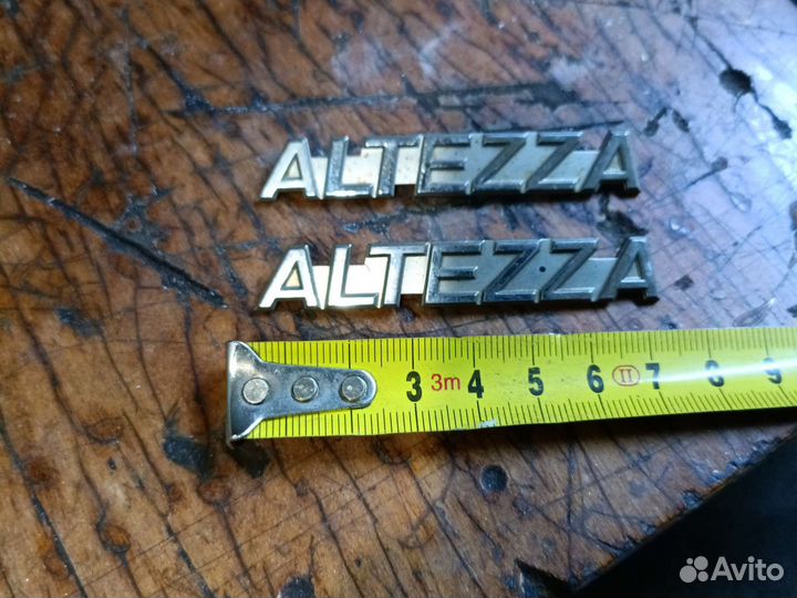 Altezza Эмблема