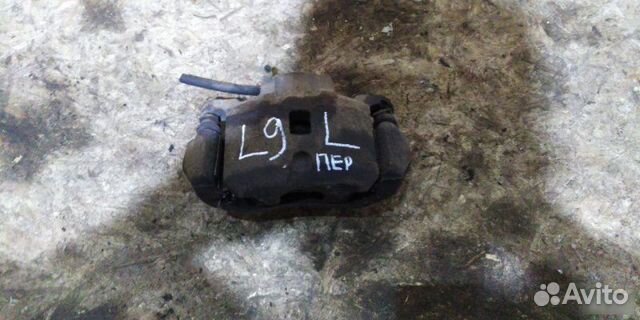 Суппорт передний левый Mitsubishi Lancer седан 1.6