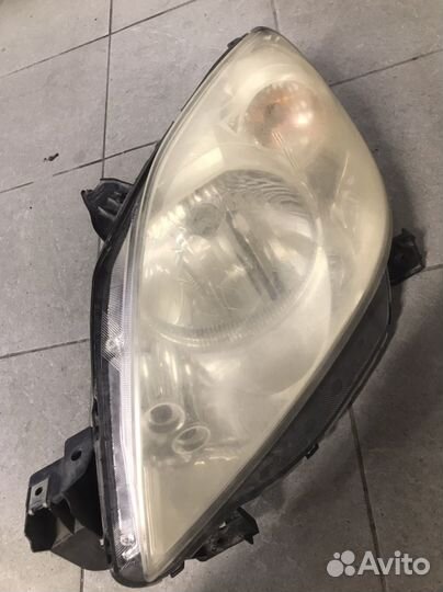 Фара левая передняя mazda demio рестаил