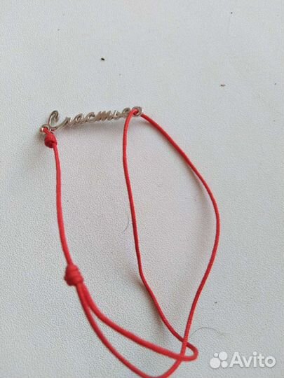 Красная нить с надписью из серебра
