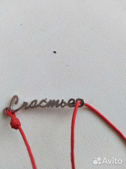 Красная нить с надписью из серебра
