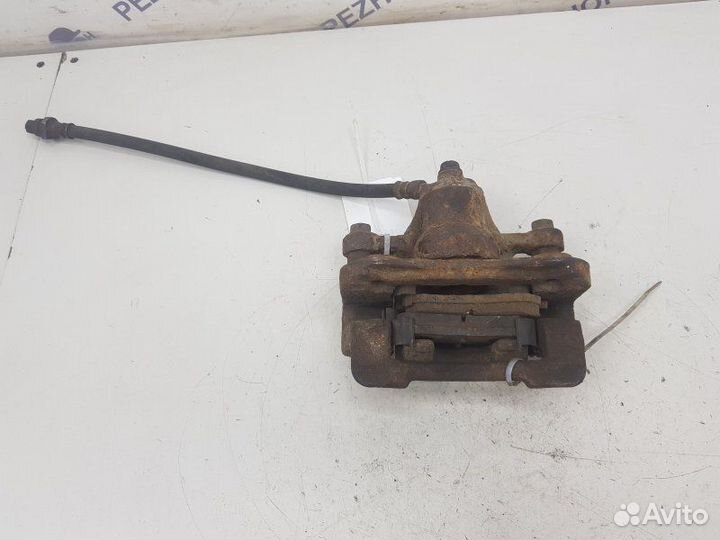 Суппорт тормозной задний левый Kia Sportage