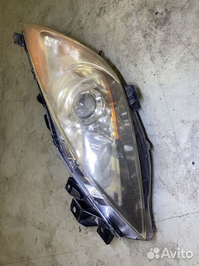 Фара левая 100-41343 Mazda Axela BL BL6FJ bleap ми