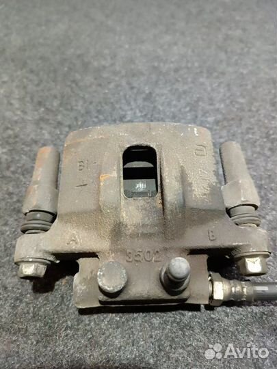 Суппорт тормозной задний левый Mitsubishi Lancer