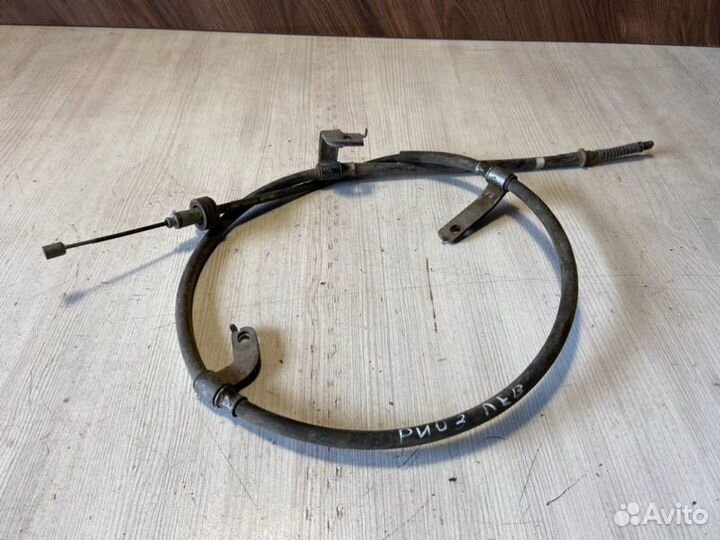 Трос стояночного тормоза левый Kia Rio 3