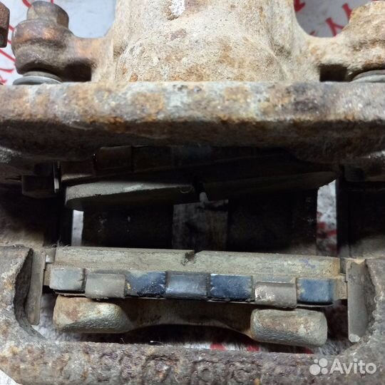 Суппорт тормозной задний левый Nissan X Trail T30