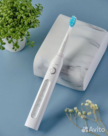 Электрическая зубная щетка