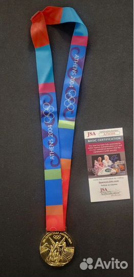 Автограф на Олимпийской медали Майкла Фелпса