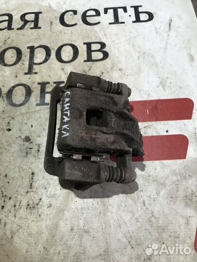 Суппорт тормозной задний левый Hyundai Santa Fe I