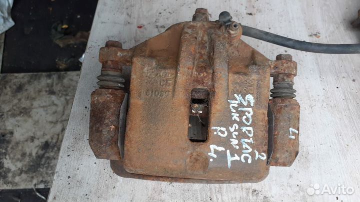 Суппорт тормозной передний левый Kia Sportage II