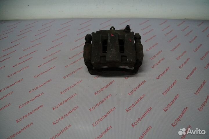 Nissan 41011-WF100 Суппорт тормозной левый