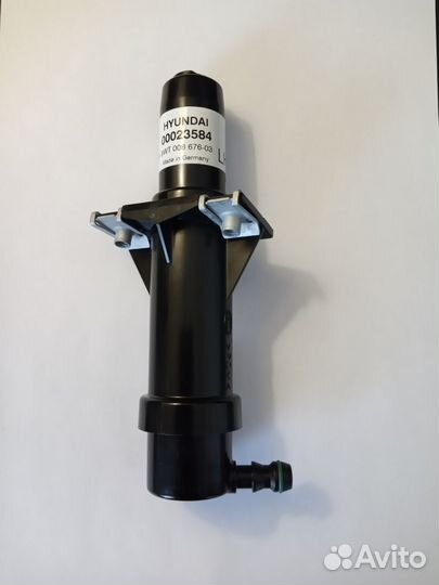 Форсунка омывателя фар левая