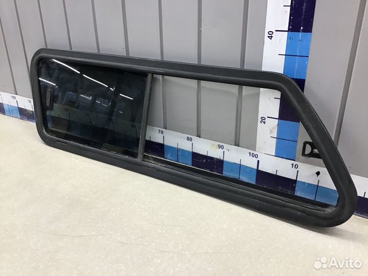 Стекло кузовное глухое левое Mitsubishi L200 (KB)