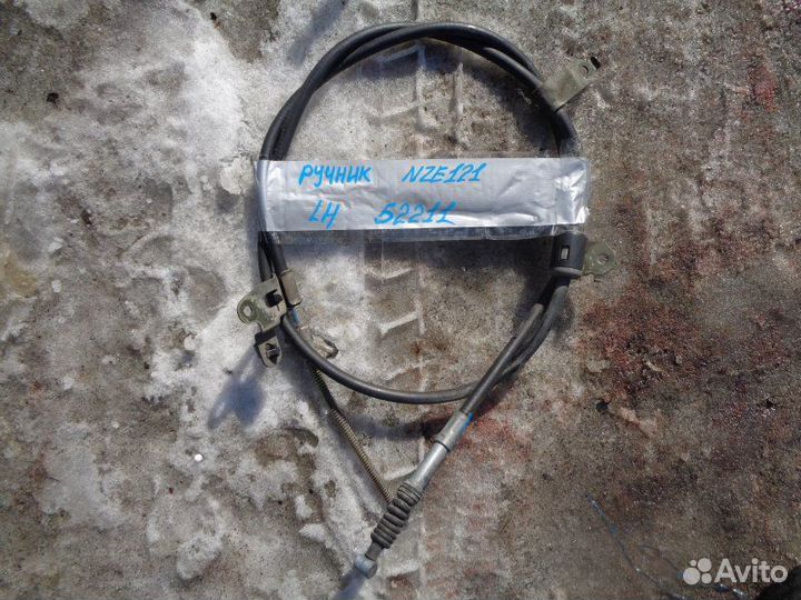 Трос ручника левый Toyota Corolla Fielder NZE121